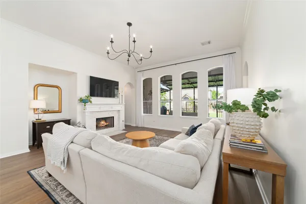 a living room with furniture and a chandelier