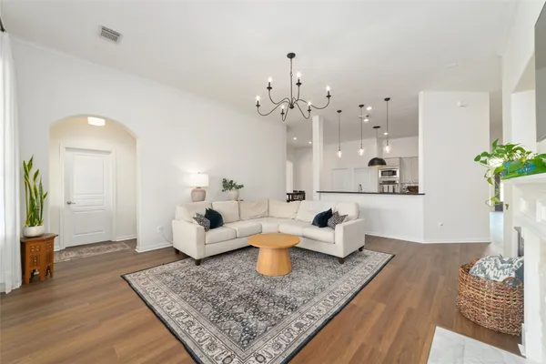 a bedroom with a large bed and a chandelier