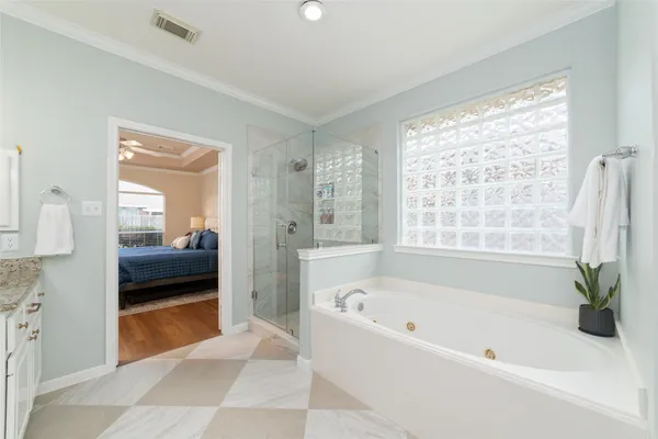 an empty room with a chandelier fan and windows