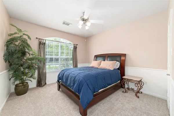 a bedroom with a bed and a potted plant
