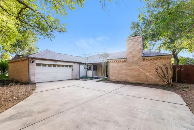 a view of a house with a yard and garage