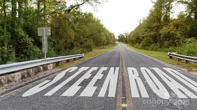 a view of a balcony with wooden floor and fence