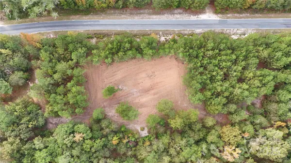a view of a yard with a wooden fence