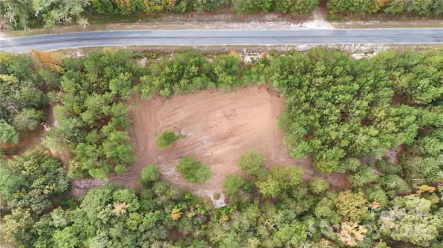 a view of a yard with a wooden fence