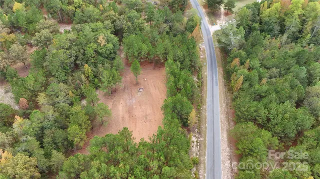 an aerial view of a house with yard