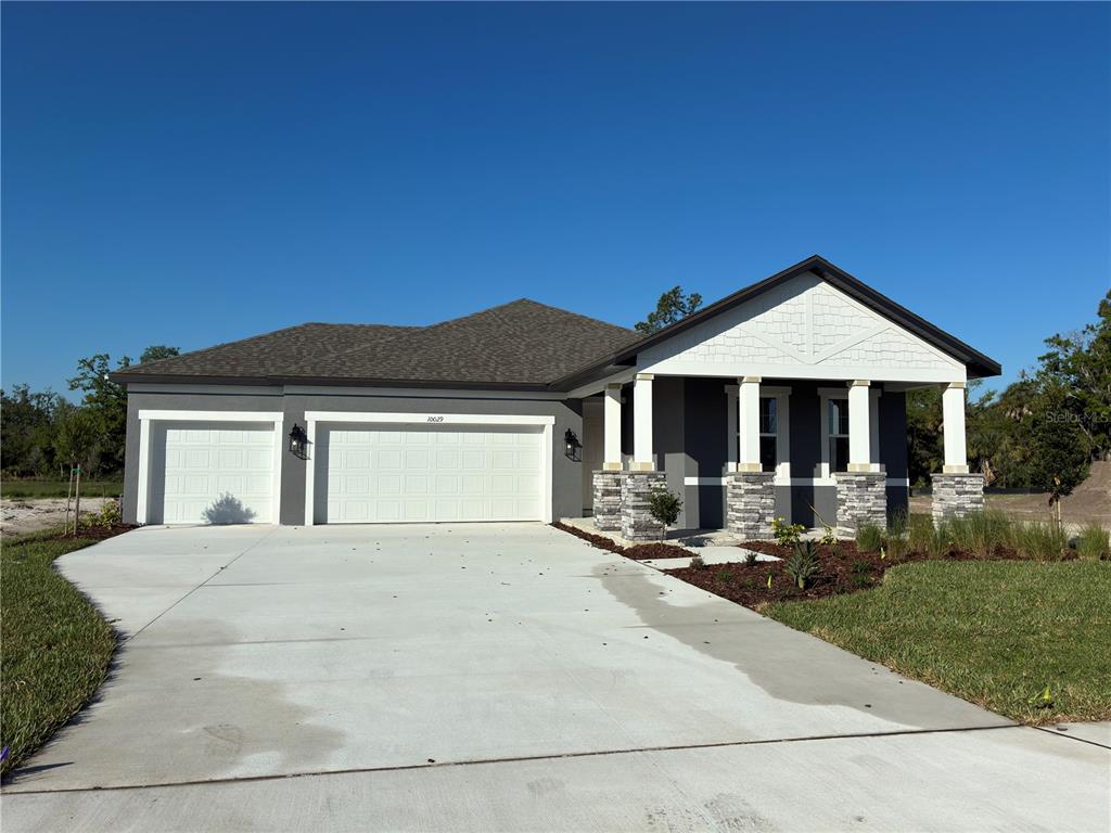 10029 Hidden Hammock Loop Parrish, FL 34221 - Photo 3 of 14 a front view of a house with yard and porch