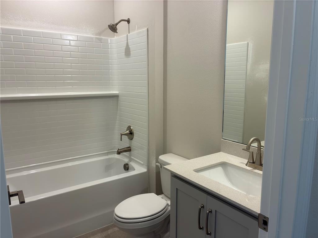 10029 Hidden Hammock Loop Parrish, FL 34221 - Photo 7 of 14 a bathroom with a granite countertop sink toilet and shower