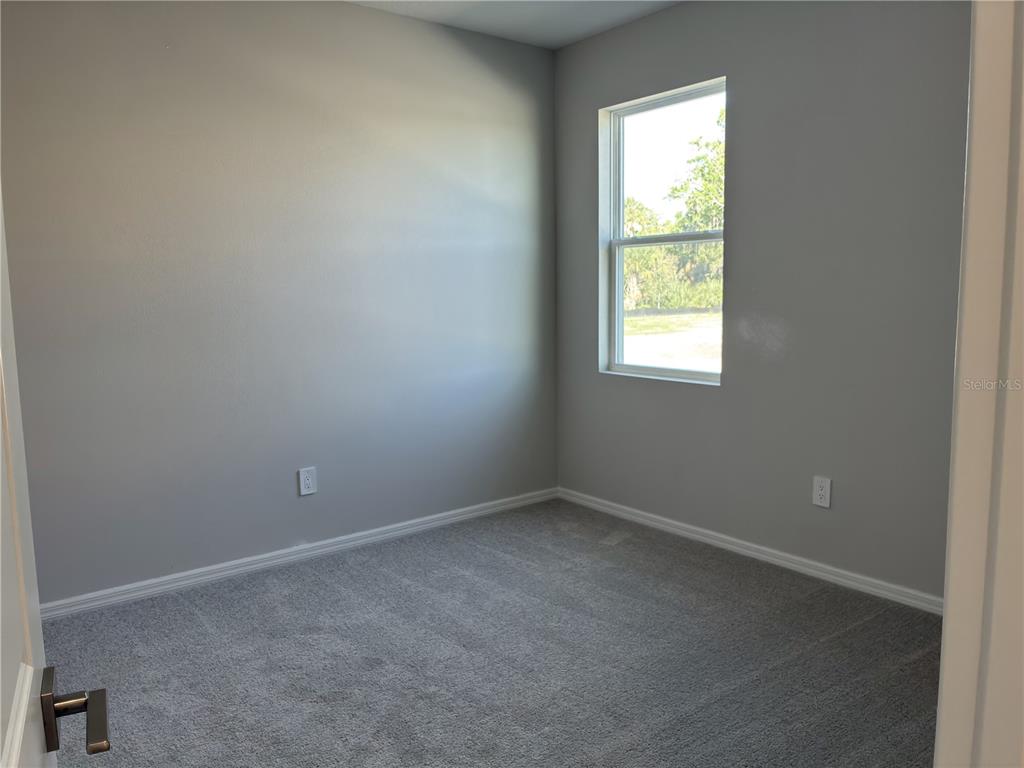 10029 Hidden Hammock Loop Parrish, FL 34221 - Photo 8 of 14 an empty room with a window