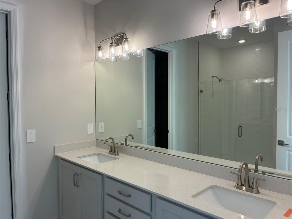 10029 Hidden Hammock Loop Parrish, FL 34221 - Photo 10 of 14 a bathroom with a sink and a mirror