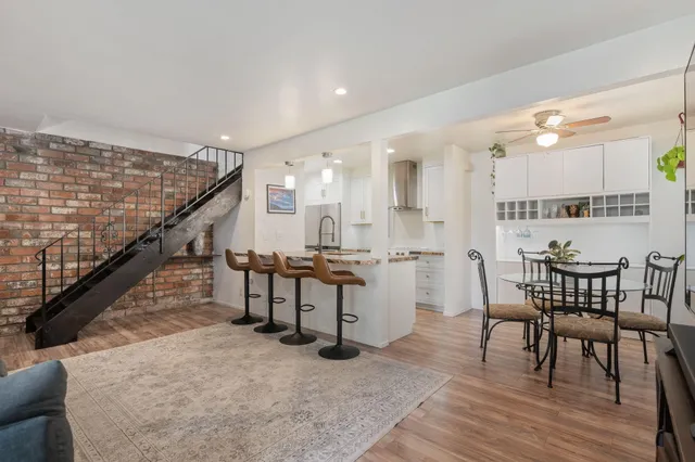 a dining room with furniture and wooden floor