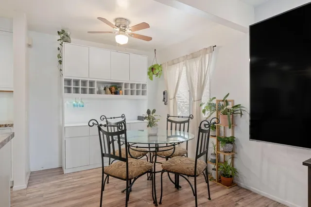 a view of a dining room with furniture and wooden floor