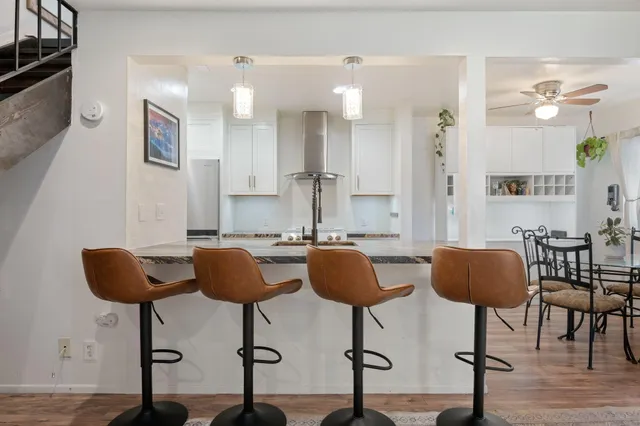 a view of kitchen with granite countertop cabinets and chair