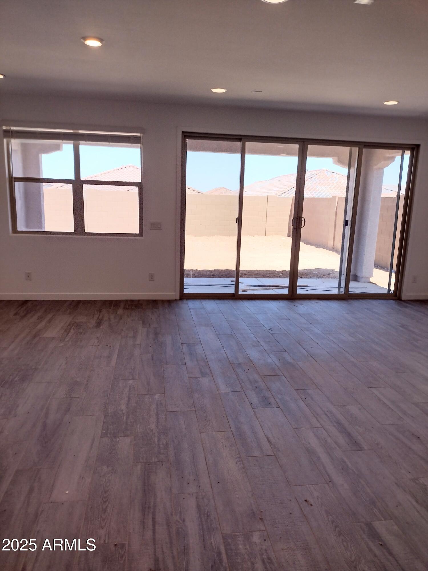 1536 West Corral Road Phoenix, AZ 85041 - Photo 6 of 16 wooden floor in an empty room with a window