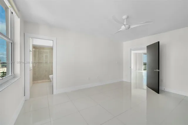 a spacious bathroom with a granite countertop sink a mirror and a shower