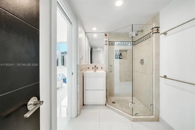 a bathroom with a shower sink and mirror
