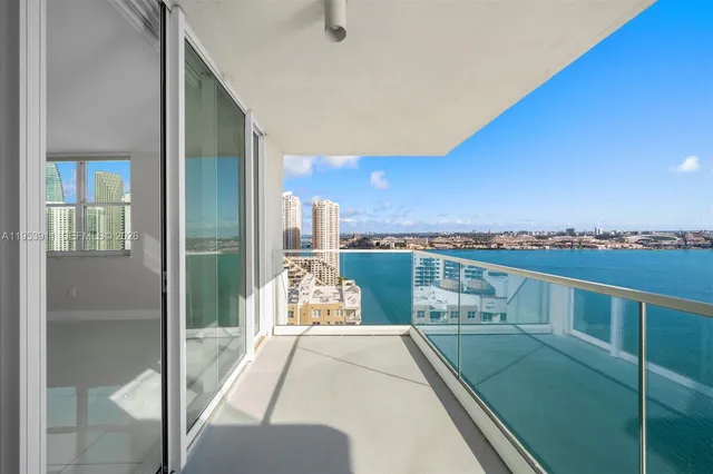 an empty room with an entryway and fan