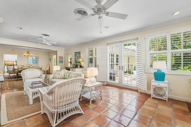 a living room with patio furniture and a large window