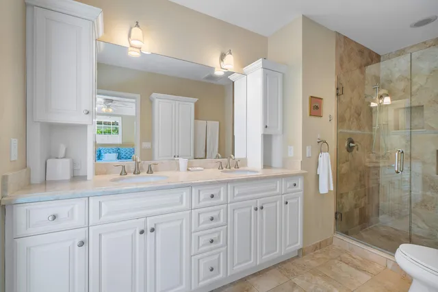 a bathroom with a granite countertop sink mirror and double