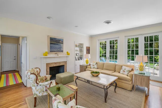 a living room with furniture fireplace and a table
