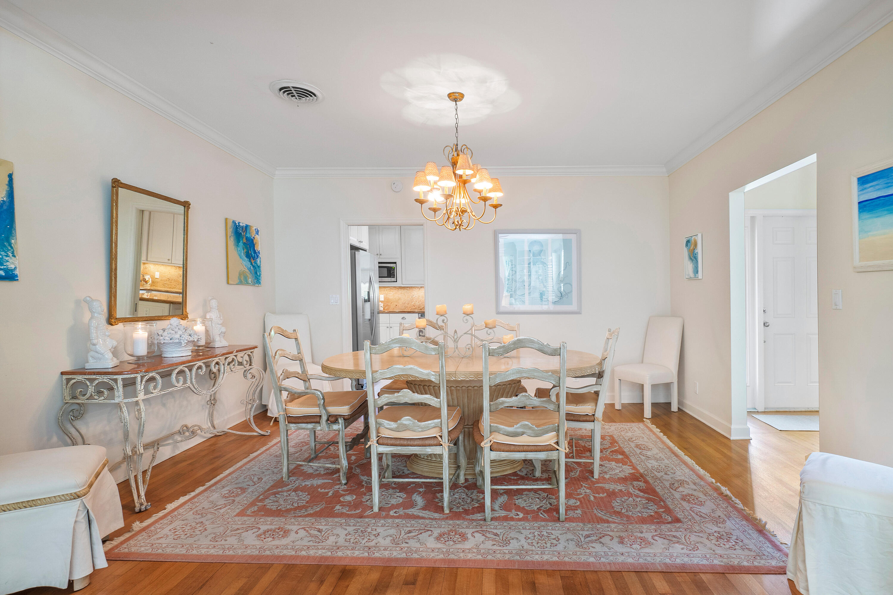 230 Plantation Road Palm Beach, FL 33480 - Photo 8 of 30 a dining room with wooden floor a chandelier a wooden table and chairs