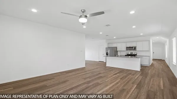 a view of kitchen with kitchen island stainless steel appliances refrigerator sink and stove