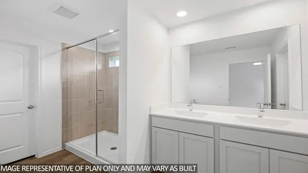 a bathroom with a shower sink and mirror