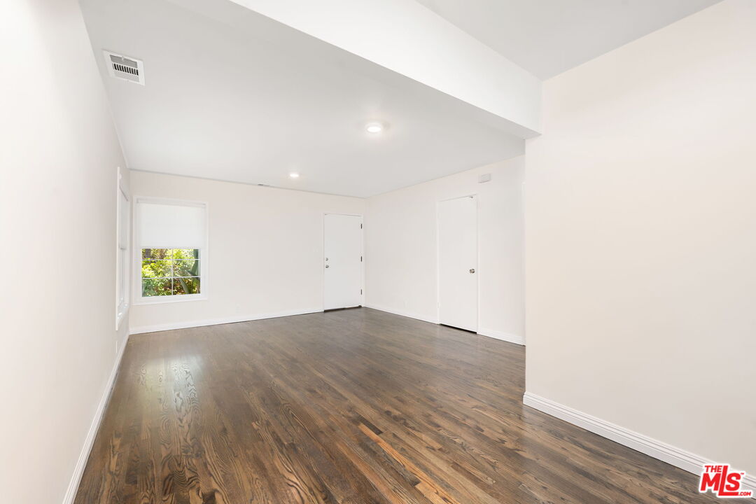 2007 East Villa Street, Unit A Pasadena, CA 91107 - Photo 6 of 12 an empty room with wooden floor and windows