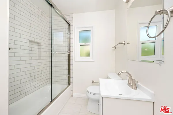 a bathroom with a toilet sink and shower