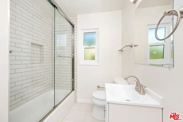 a bathroom with a toilet sink and shower