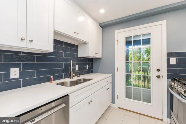 a kitchen with a sink and a refrigerator