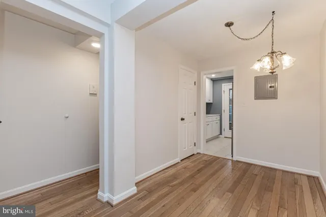 a view of a room with wooden floor and window