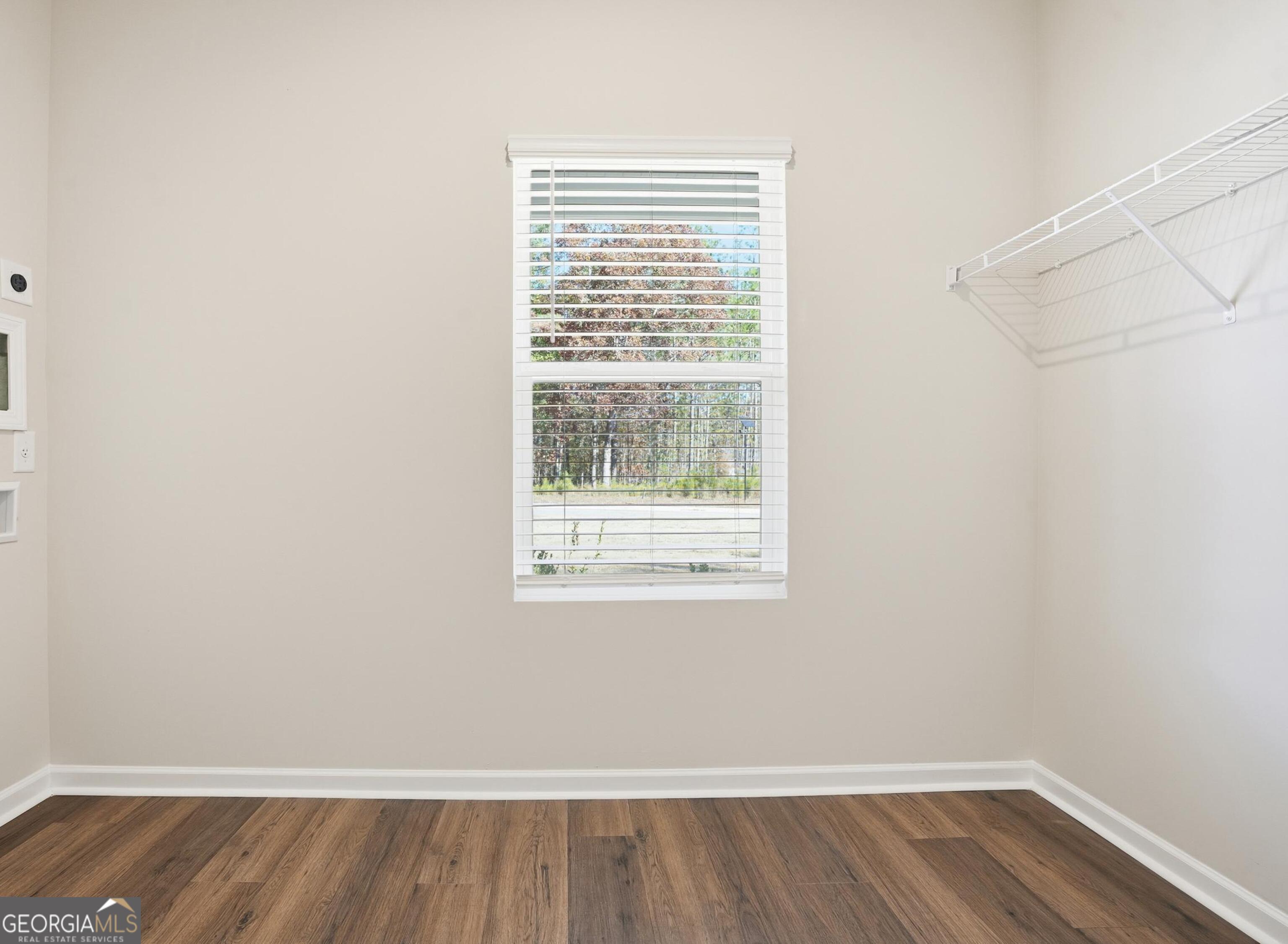 130 Post Oak Drive, Unit 130 Jackson, GA 30233 - Photo 12 of 29 a view of an empty room with wooden floor and a window