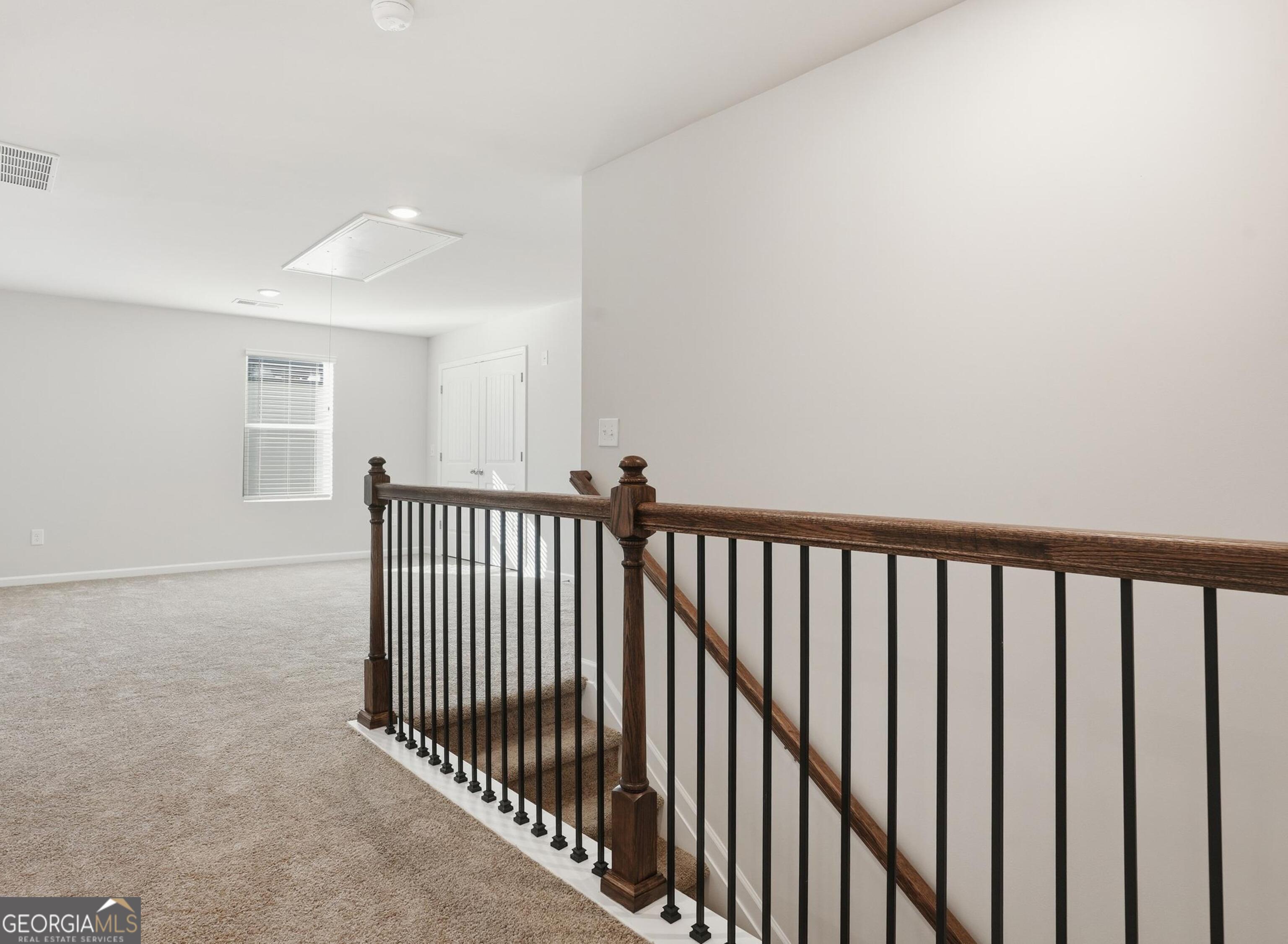 130 Post Oak Drive, Unit 130 Jackson, GA 30233 - Photo 14 of 29 a view of a hallway with wooden floor and a bathroom