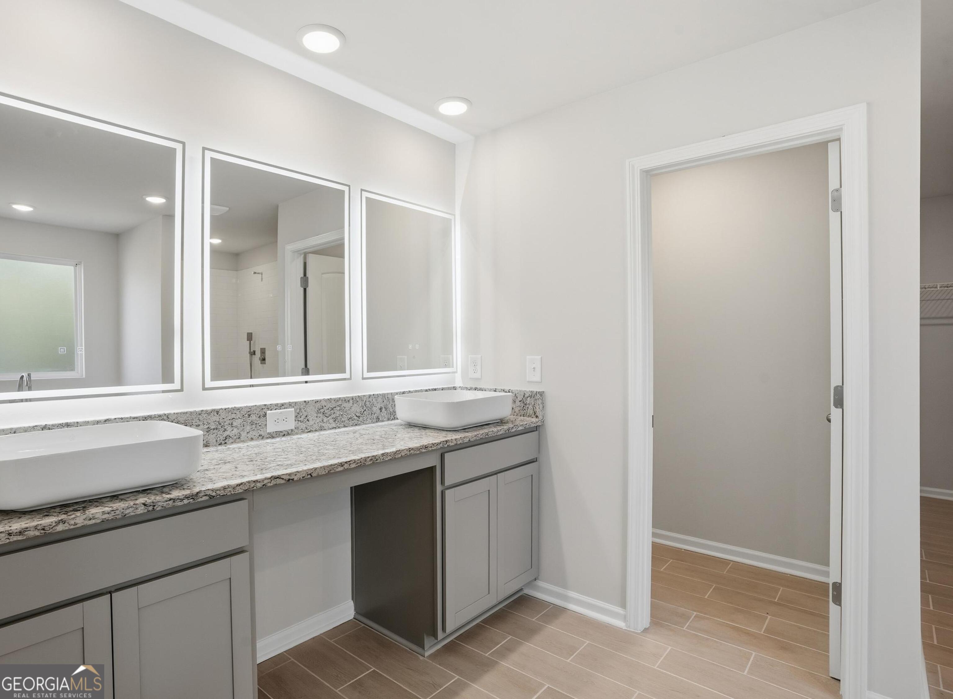 130 Post Oak Drive, Unit 130 Jackson, GA 30233 - Photo 18 of 29 a bathroom with a granite countertop sink and a mirror