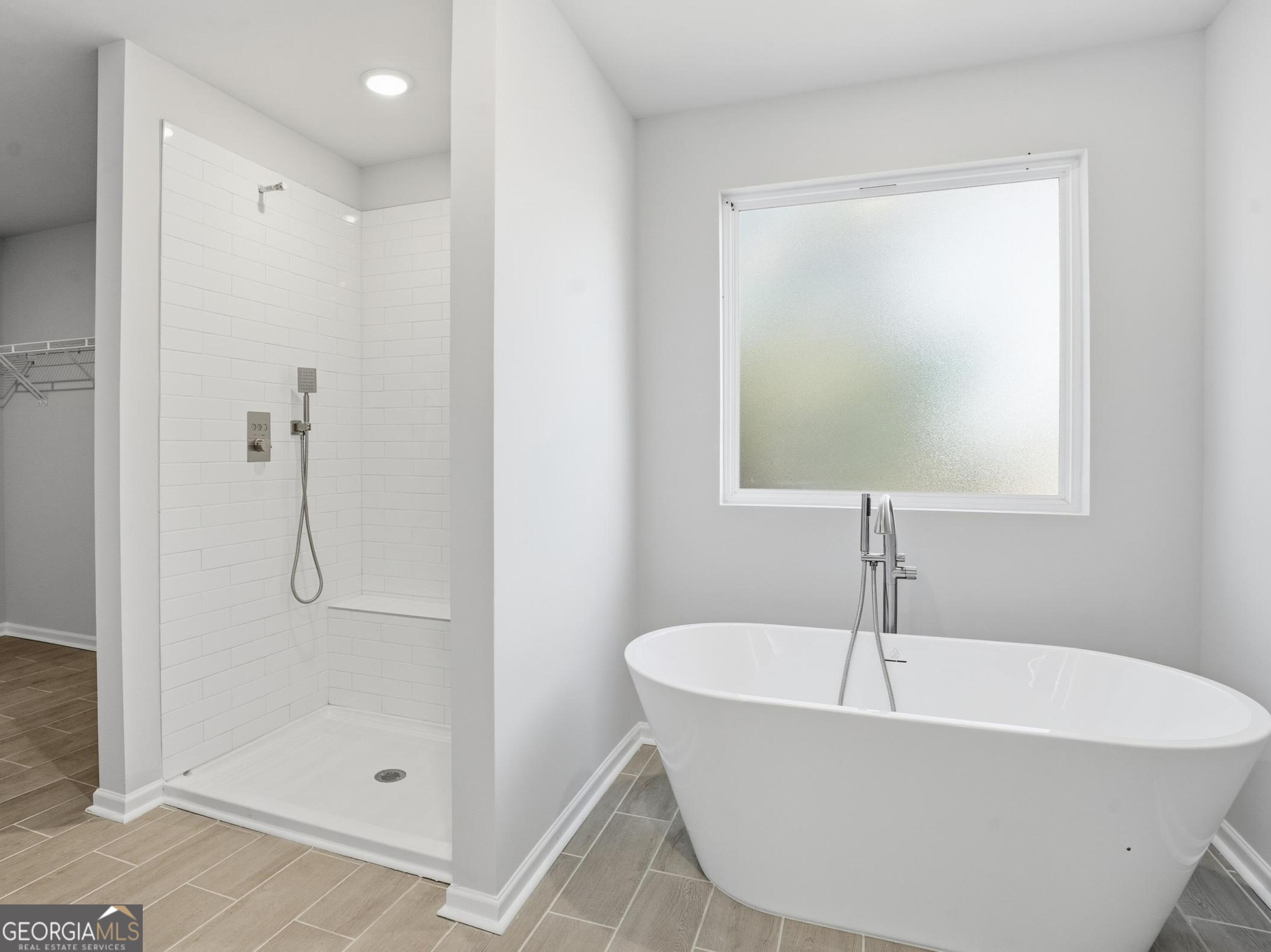 130 Post Oak Drive, Unit 130 Jackson, GA 30233 - Photo 19 of 29 a white bath tub sitting next to a shower