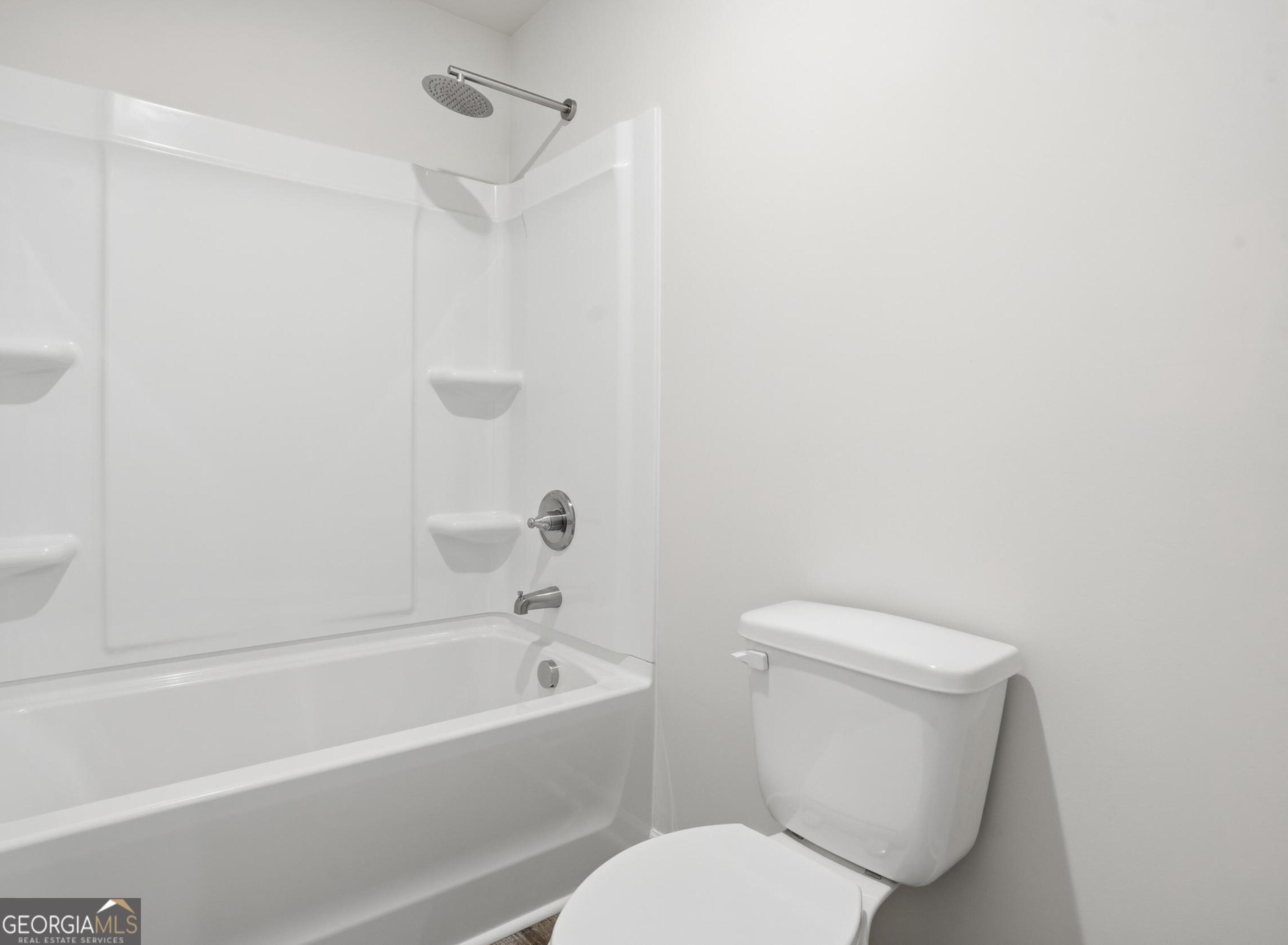 130 Post Oak Drive, Unit 130 Jackson, GA 30233 - Photo 24 of 29 a white toilet and tub sitting next to a bathroom sink