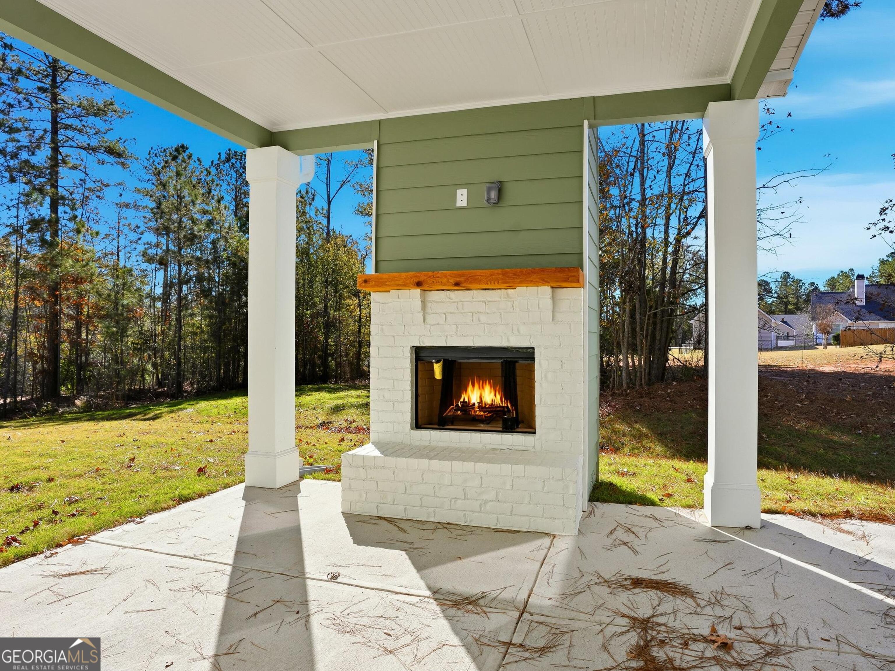 130 Post Oak Drive, Unit 130 Jackson, GA 30233 - Photo 28 of 29 a living room with a fireplace and a floor to ceiling window