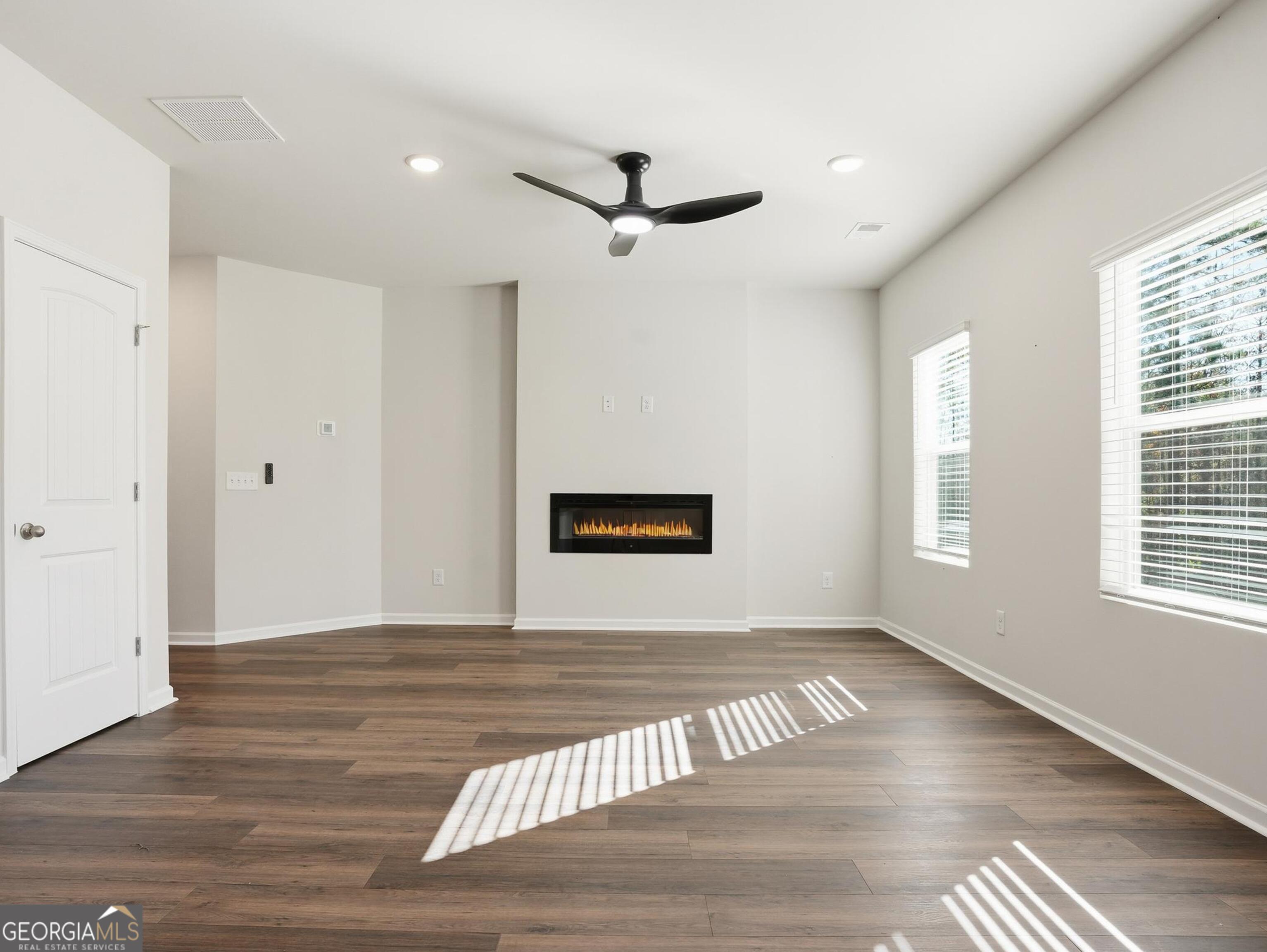 130 Post Oak Drive, Unit 130 Jackson, GA 30233 - Photo 3 of 29 a view of an empty room with wooden floor and a window