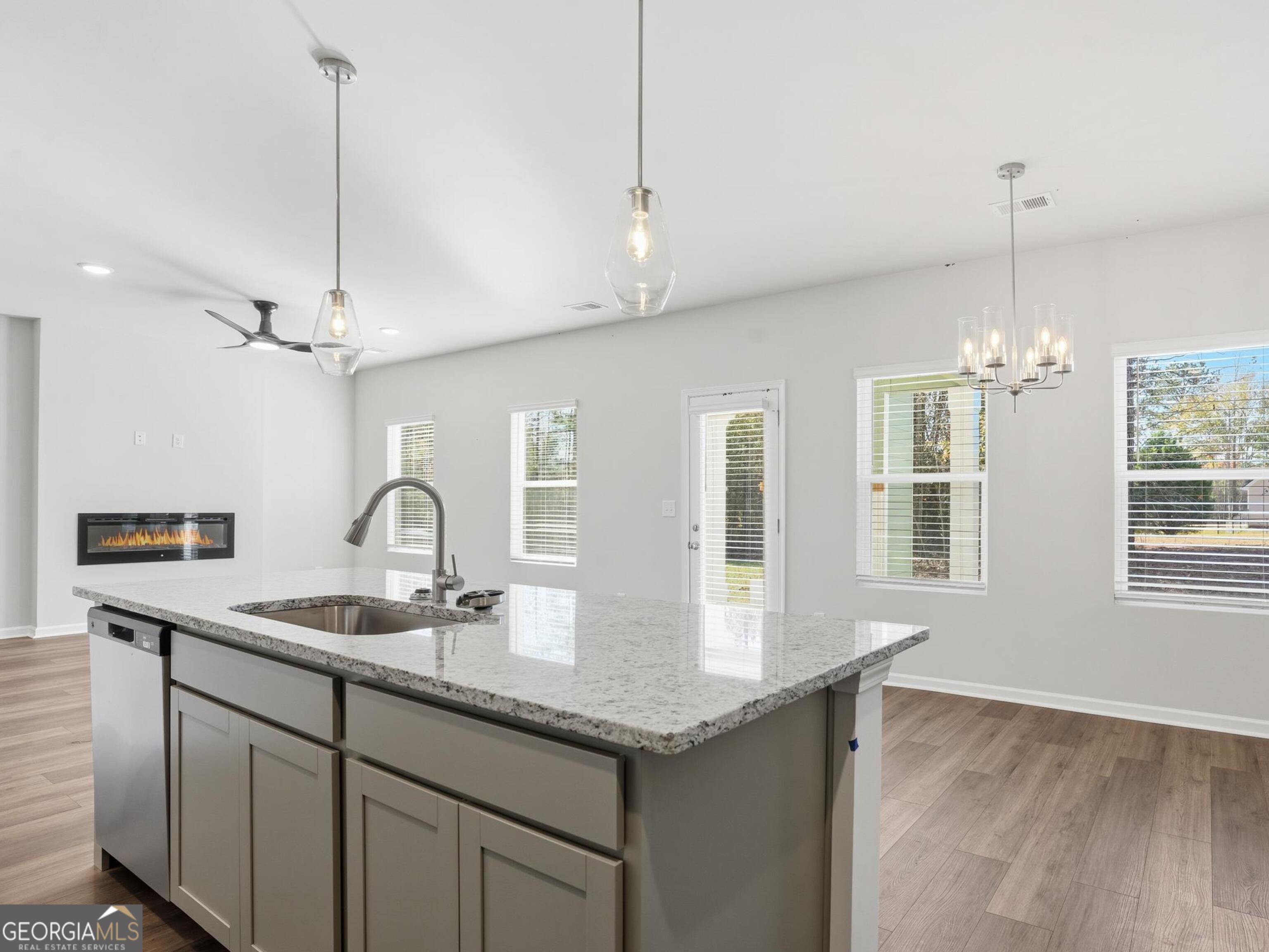 130 Post Oak Drive, Unit 130 Jackson, GA 30233 - Photo 5 of 29 a kitchen with granite countertop a sink cabinets and wooden floor