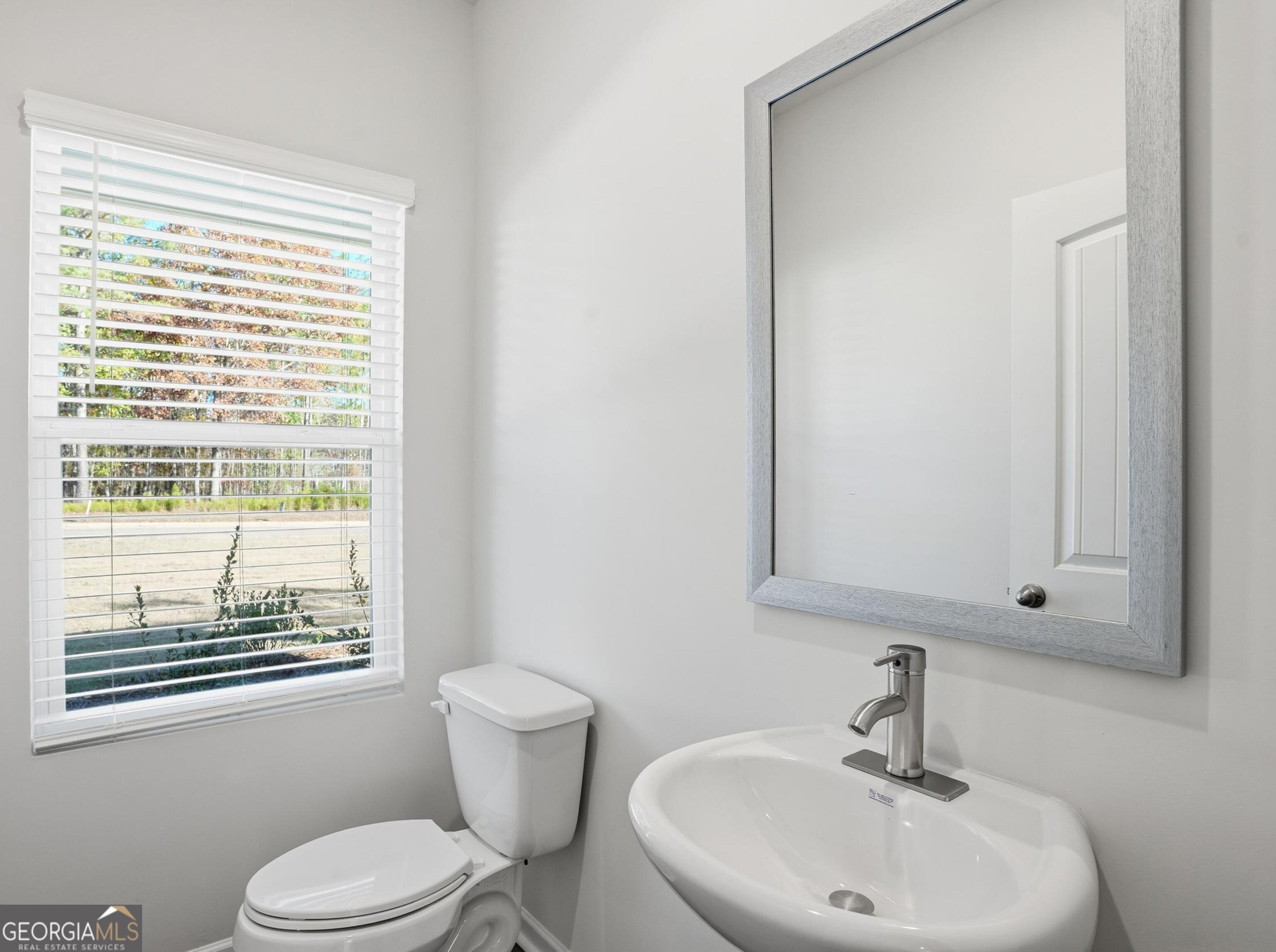 130 Post Oak Drive, Unit 130 Jackson, GA 30233 - Photo 7 of 29 a bathroom with a sink toilet and mirror