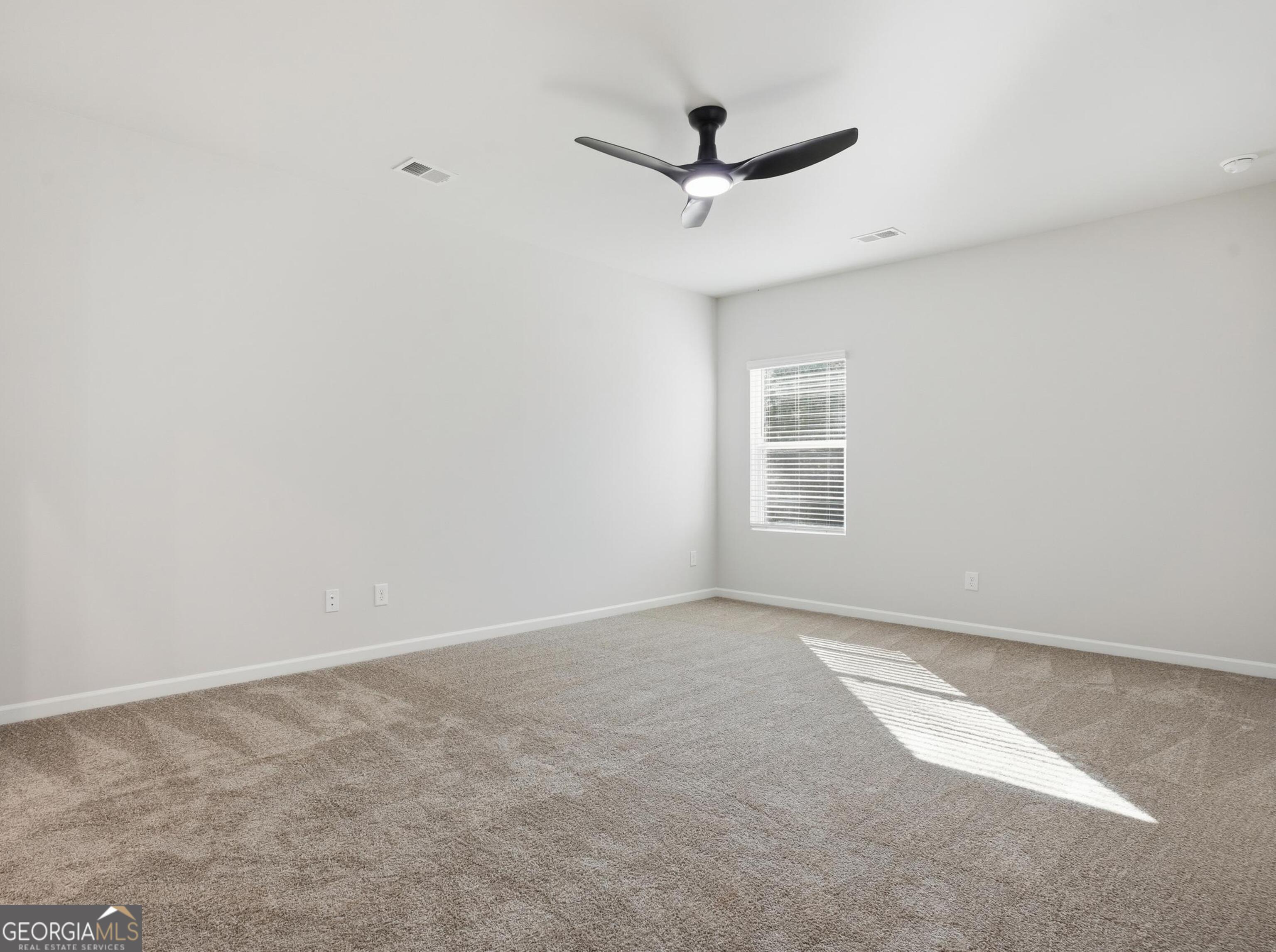 130 Post Oak Drive, Unit 130 Jackson, GA 30233 - Photo 8 of 29 an empty room with a window and a ceiling fan