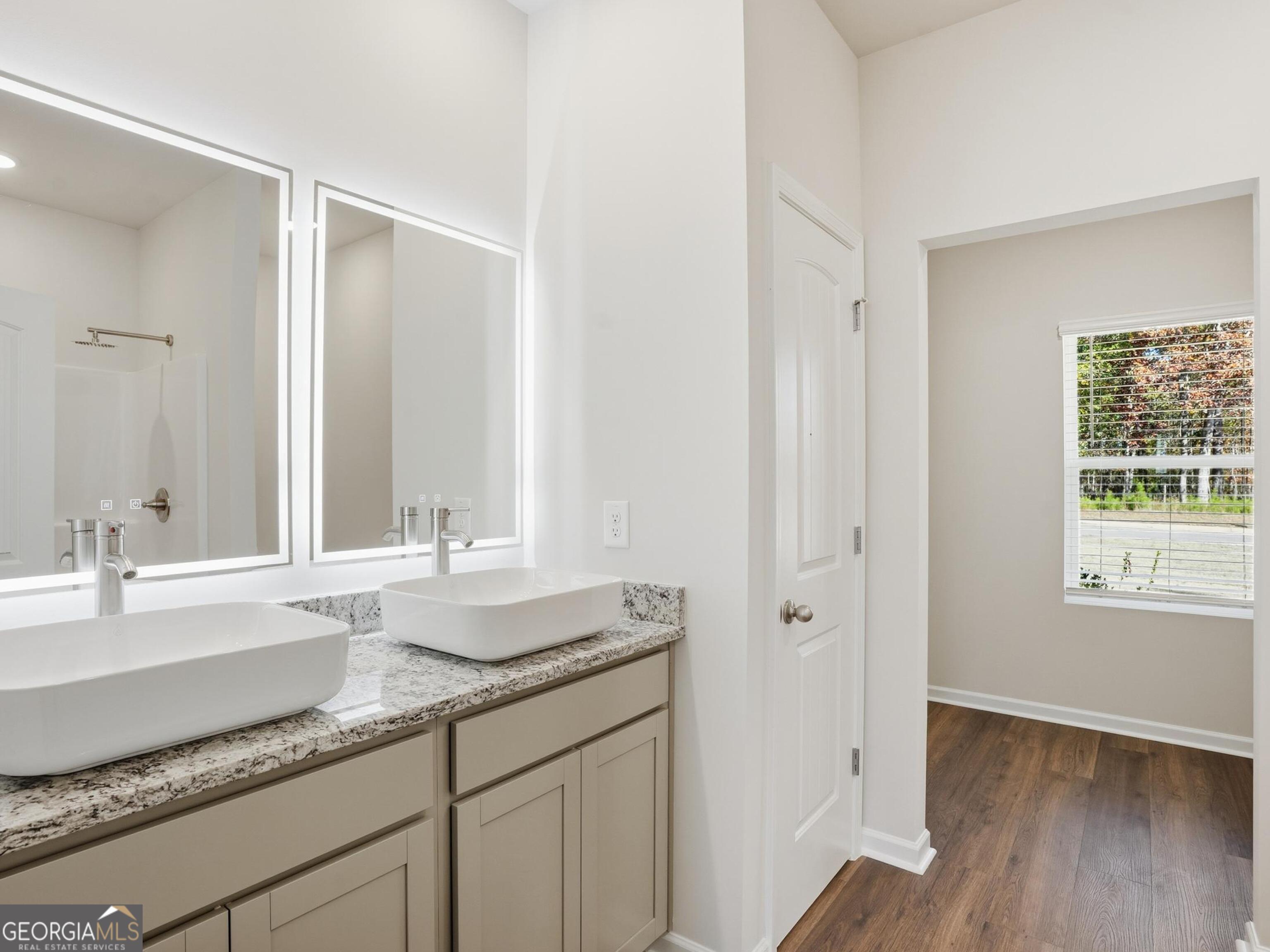 130 Post Oak Drive, Unit 130 Jackson, GA 30233 - Photo 10 of 29 a bathroom with a granite countertop sink and a mirror