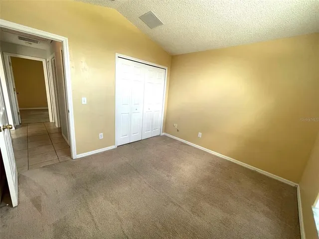 a view of a room with a wooden door