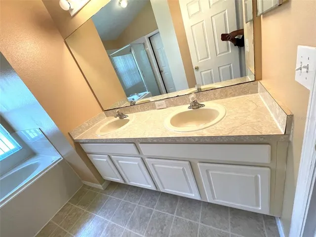 a bathroom with a bathtub and a window