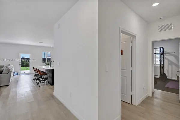 a view of a livingroom with furniture and hardwood floor