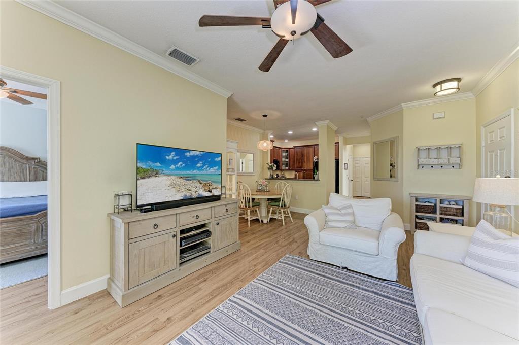 8015 Limestone Lane, Unit 15101 Sarasota, FL 34233 - Photo 12 of 46 a living room with furniture and a flat screen tv