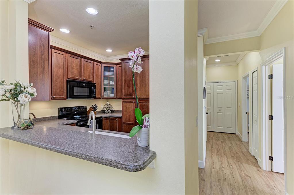 8015 Limestone Lane, Unit 15101 Sarasota, FL 34233 - Photo 15 of 46 a kitchen with sink refrigerator and microwave