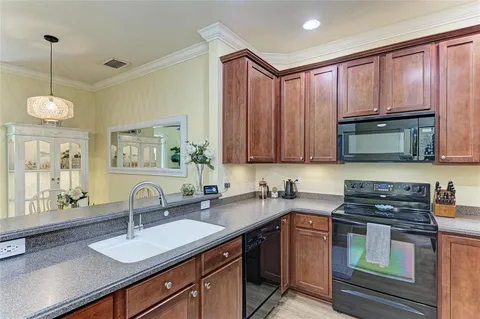 a kitchen with a sink stove and microwave