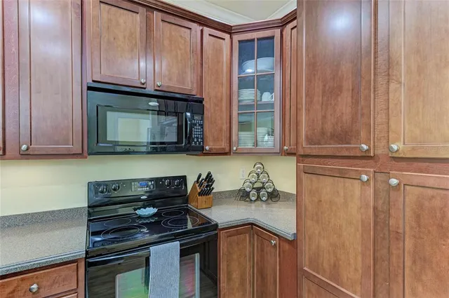 a kitchen with granite countertop cabinets and black appliances