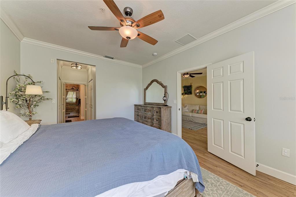 8015 Limestone Lane, Unit 15101 Sarasota, FL 34233 - Photo 20 of 46 a bedroom with a large bed and a dresser